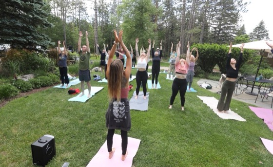Guests in an outdoor group yoga class at a VWR retreat