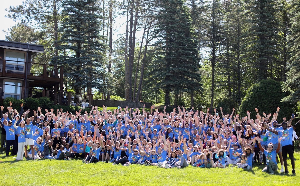 Vegan Wellness Retreats 2027 guests in blue shirts on the lawn at LoneHollow Ranch